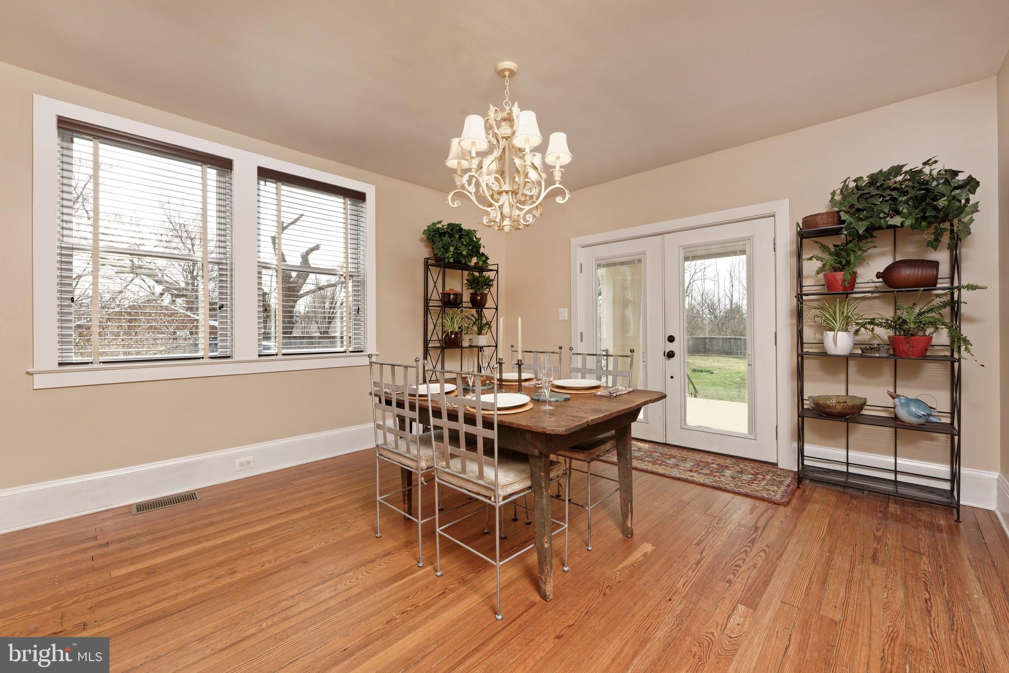 4048 Rectortown Road Marshall, VA 20115 - Photo 12 of 52 a dining room with wooden floor a chandelier a wooden table and chairs