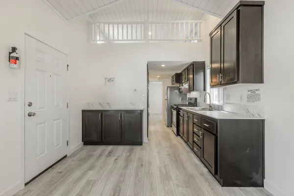 a kitchen with stainless steel appliances granite countertop a sink and cabinets