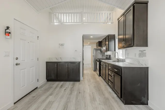 a kitchen with stainless steel appliances granite countertop a sink and cabinets