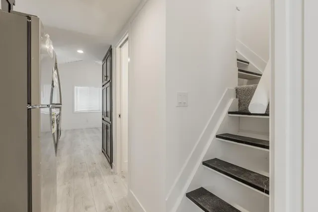 a view of entryway and hall with wooden floor