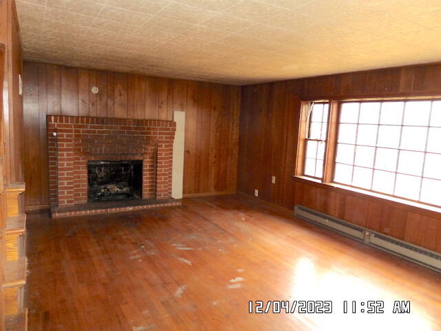 5982 Brethren Road Roanoke, VA 24014 - Photo 3 of 10 a view of an empty room with a fireplace and a window