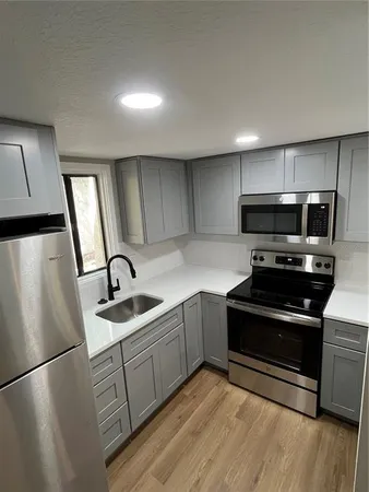 a kitchen with stainless steel appliances a refrigerator stove and sink