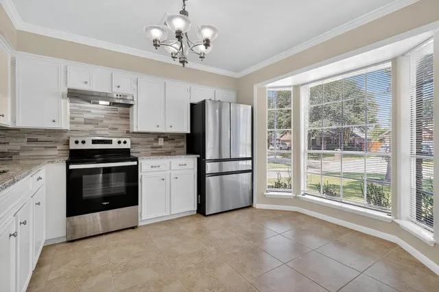 a kitchen with stainless steel appliances a stove sink and refrigerator