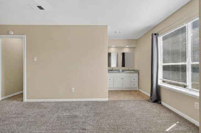 a view of a kitchen with white cabinets and sink