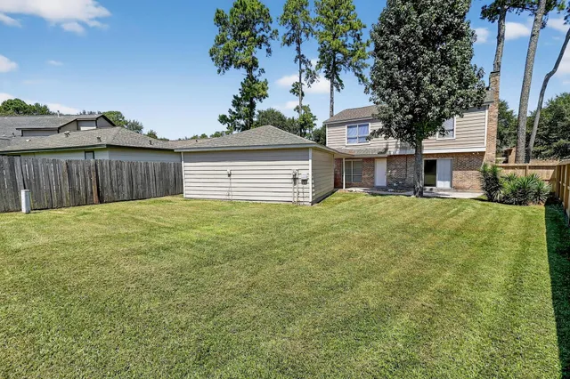 a view of a house with a yard and garage