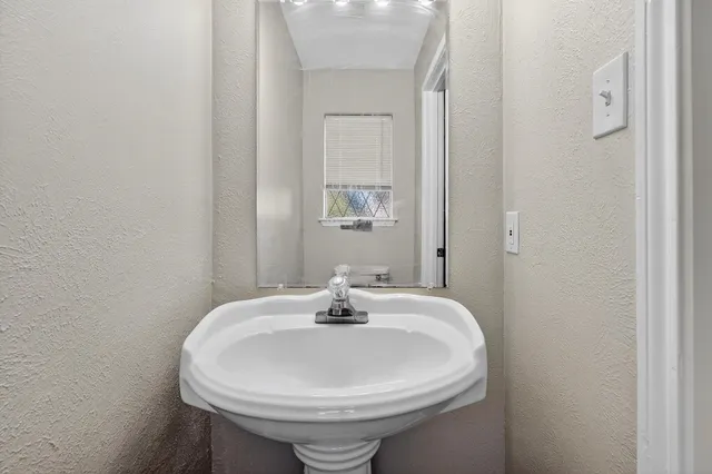 a bathroom with a sink and a mirror