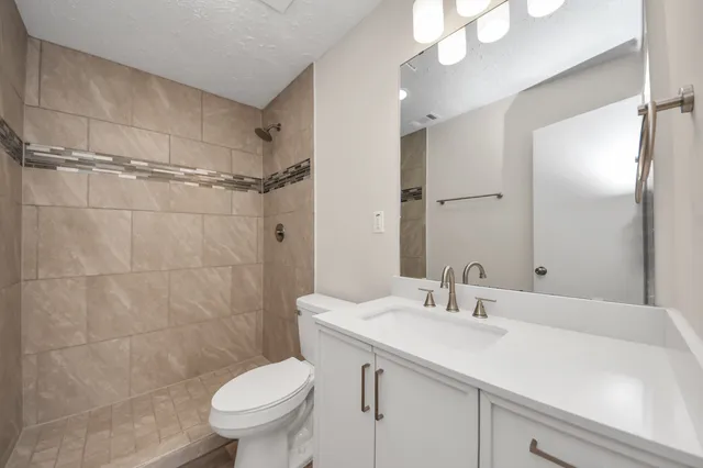 a bathroom with a sink toilet and shower
