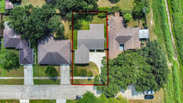 an aerial view of house with yard and outdoor seating