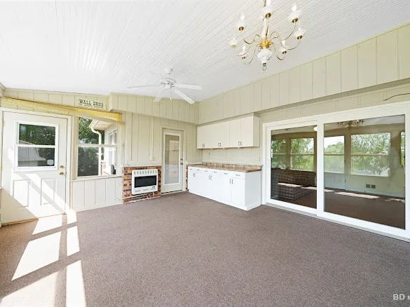 a large white kitchen with a large window
