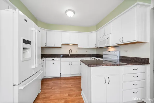 a kitchen with granite countertop a sink and cabinets
