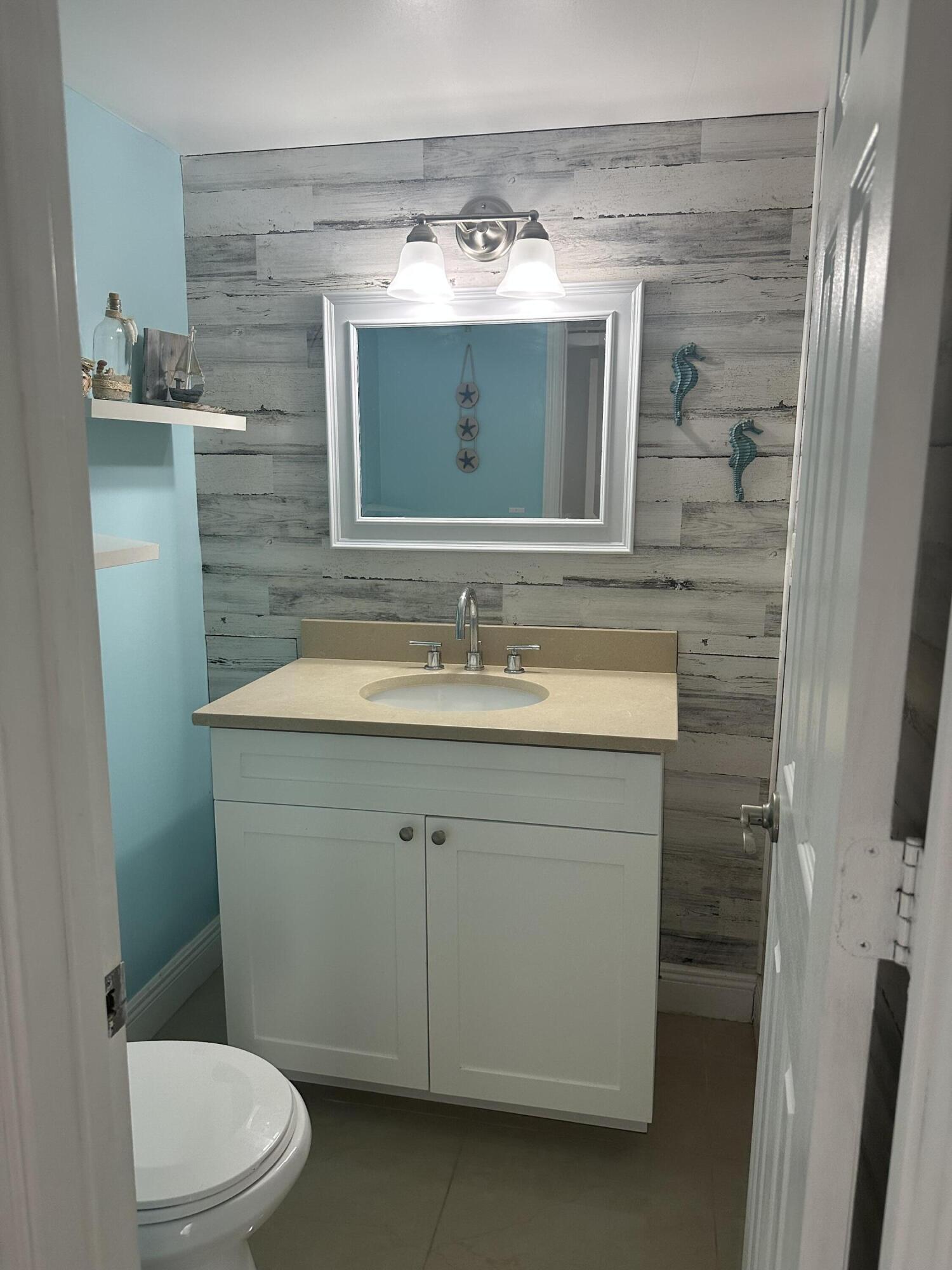 2201 White Pine Circle, Unit B Greenacres, FL 33415 - Photo 8 of 14 a bathroom with a sink and a mirror