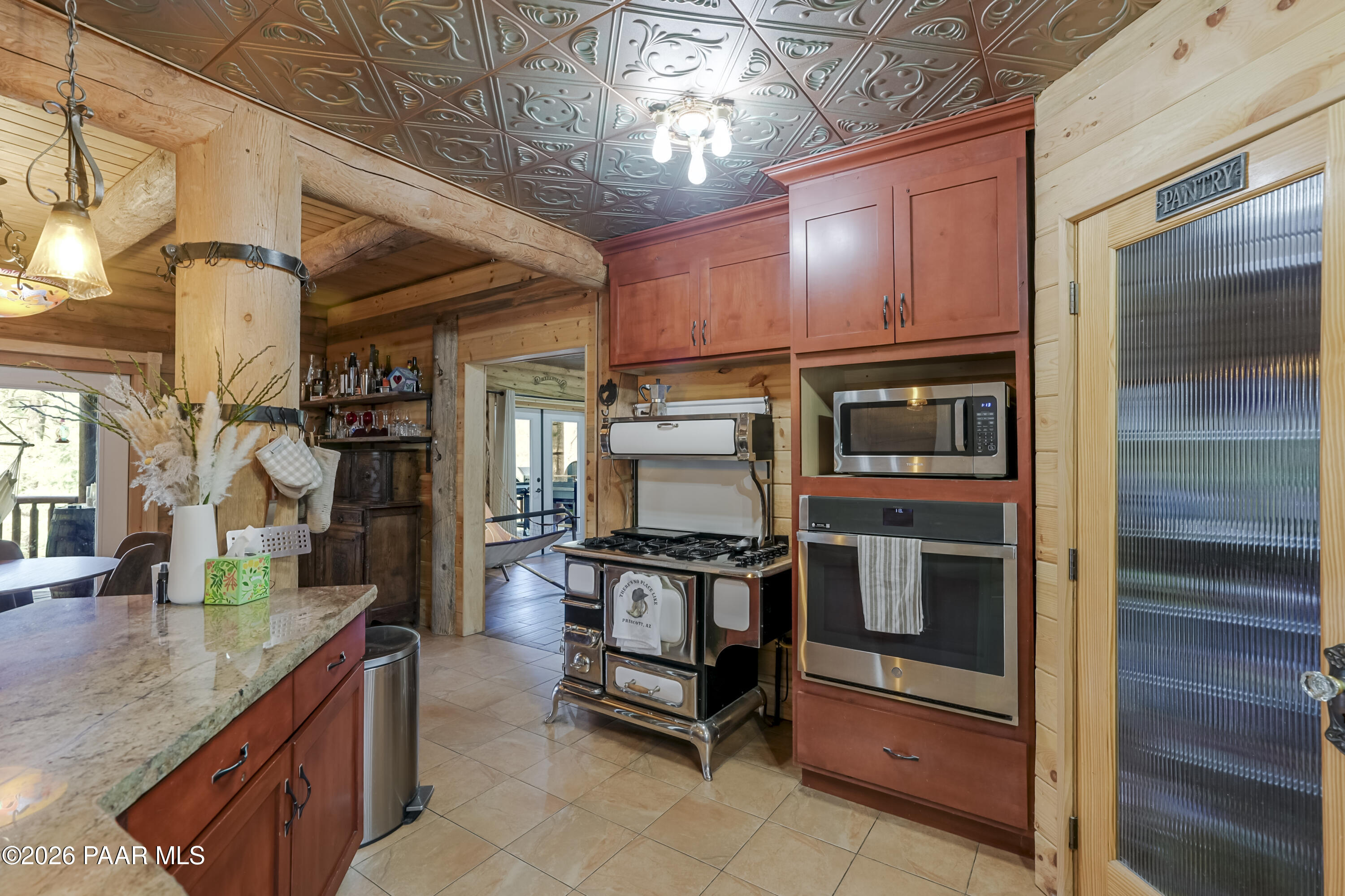 8105 South Comstock Mine Road Prescott, AZ 86303 - Photo 13 of 61 a kitchen with stainless steel appliances granite countertop a stove and a microwave