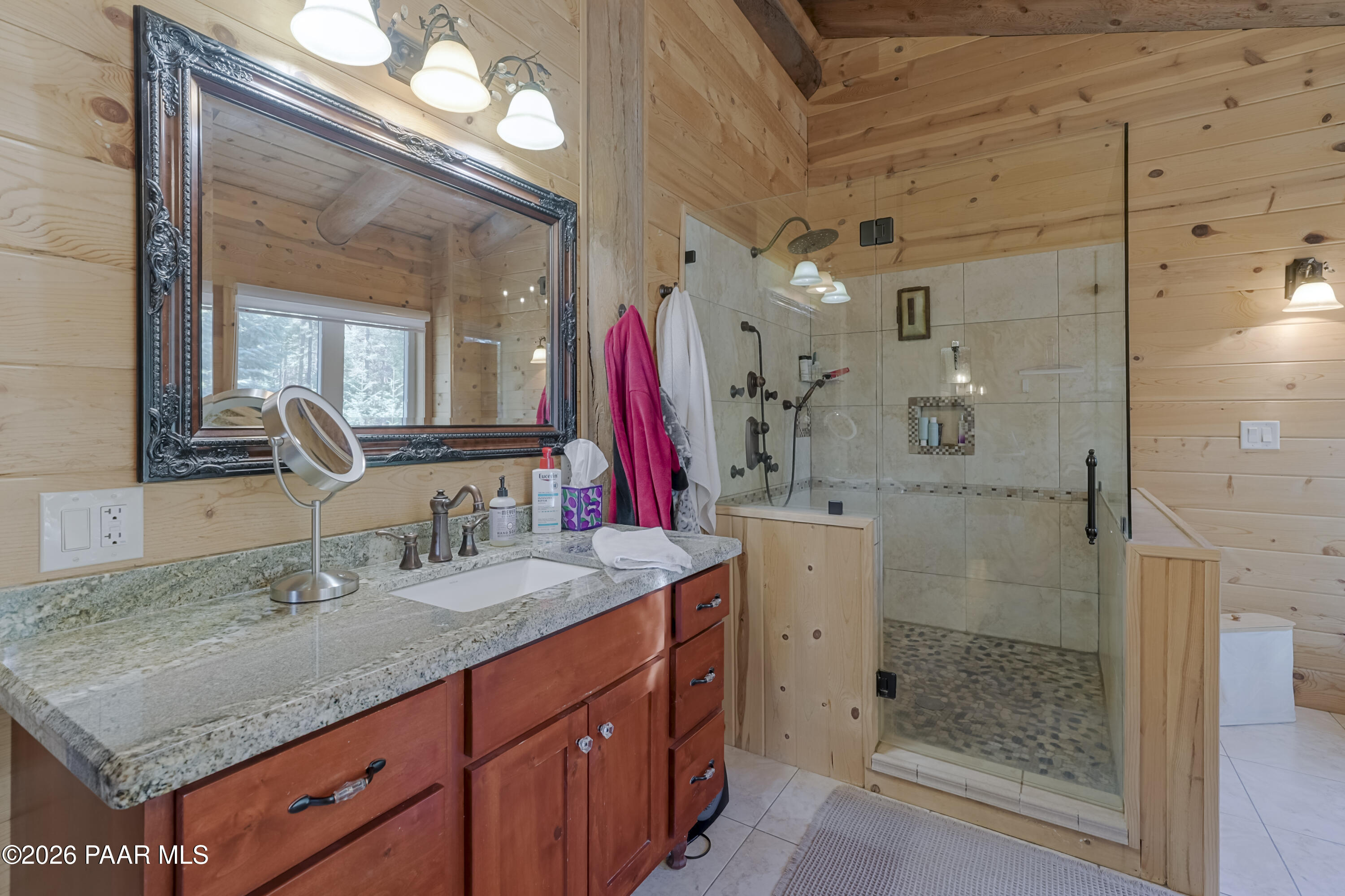 8105 South Comstock Mine Road Prescott, AZ 86303 - Photo 20 of 61 a bathroom with a granite countertop shower a sink and a mirror