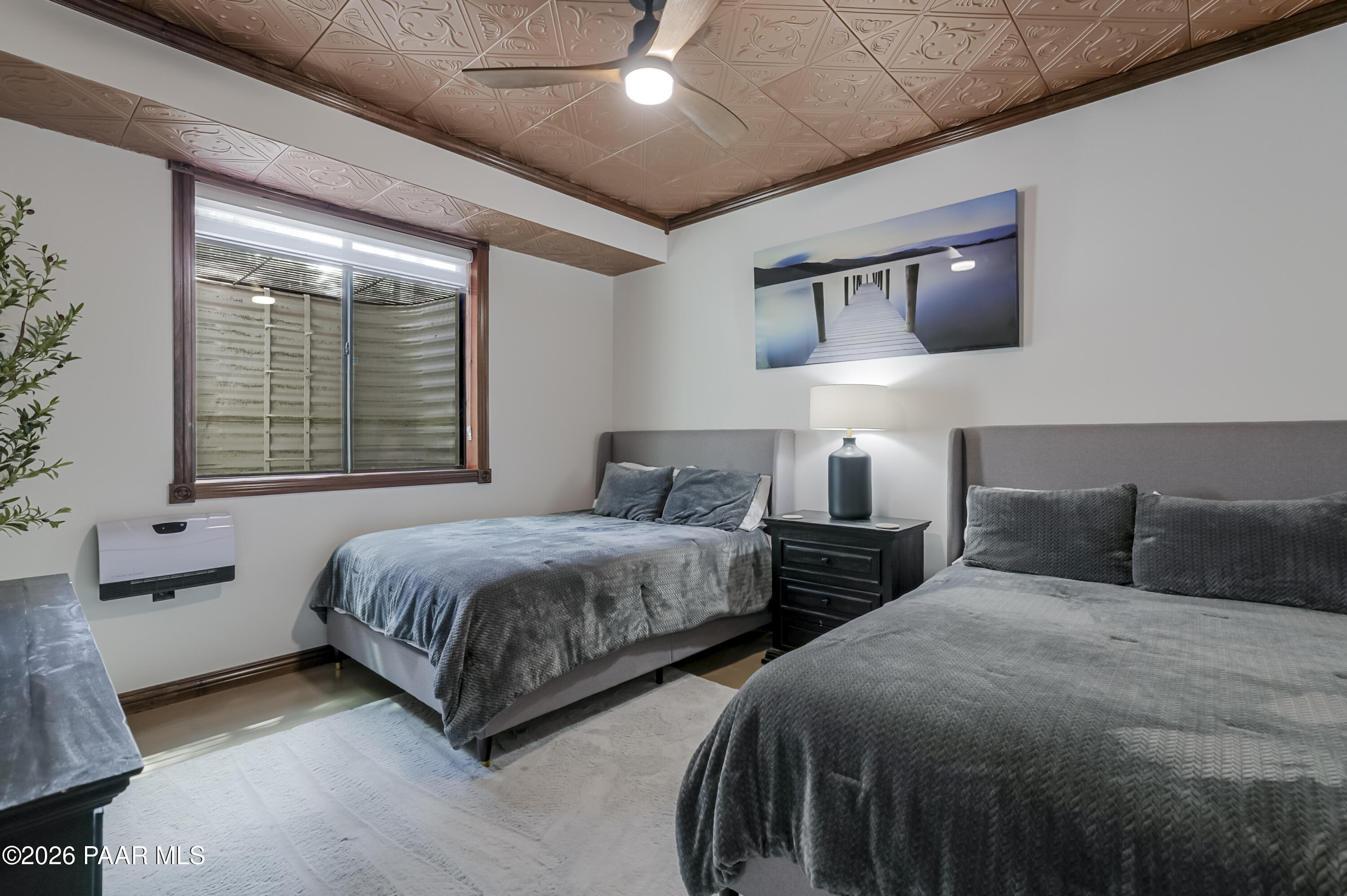 8105 South Comstock Mine Road Prescott, AZ 86303 - Photo 28 of 61 a bedroom with two beds and a large window