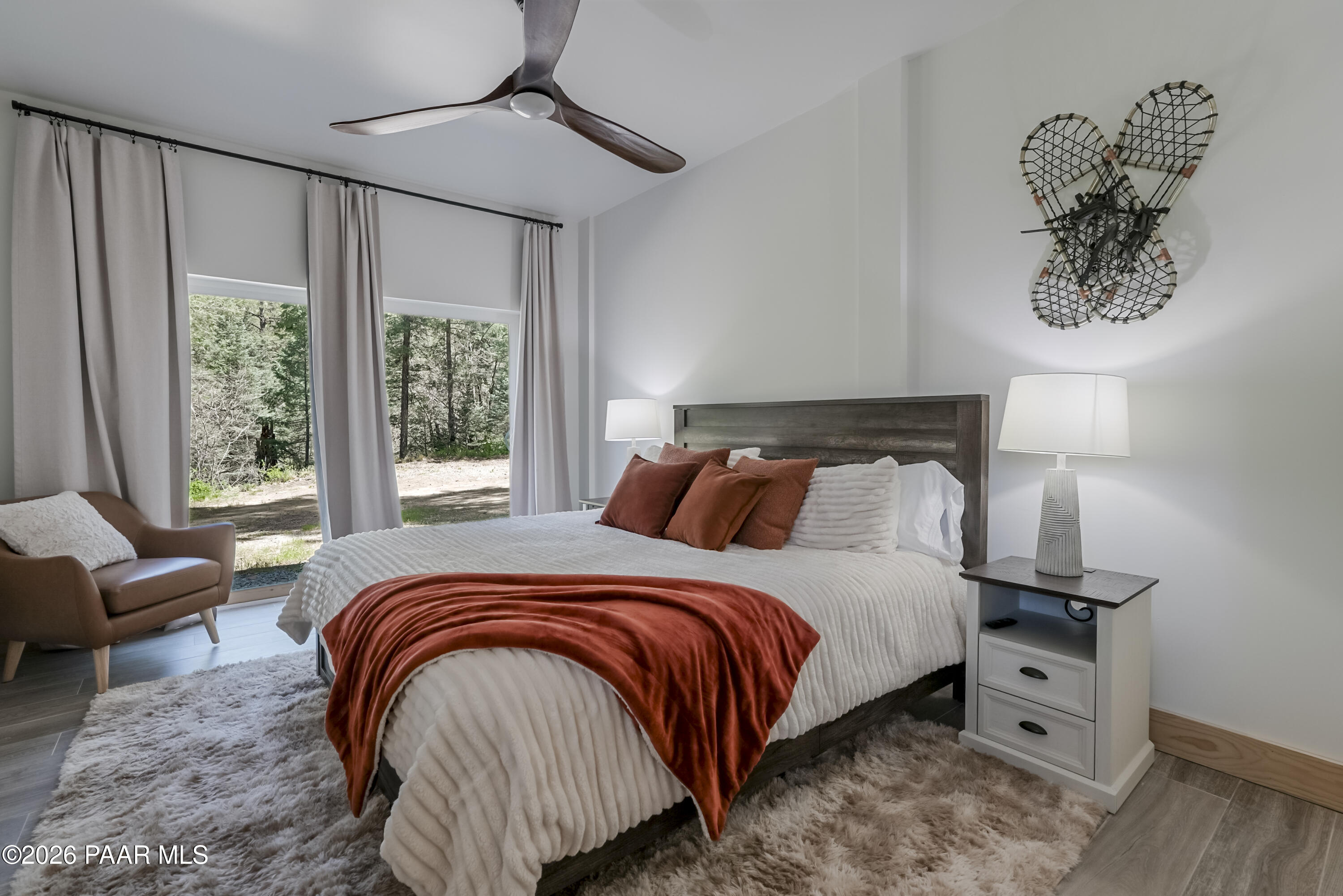 8105 South Comstock Mine Road Prescott, AZ 86303 - Photo 29 of 61 a bedroom with a bed and wooden floor