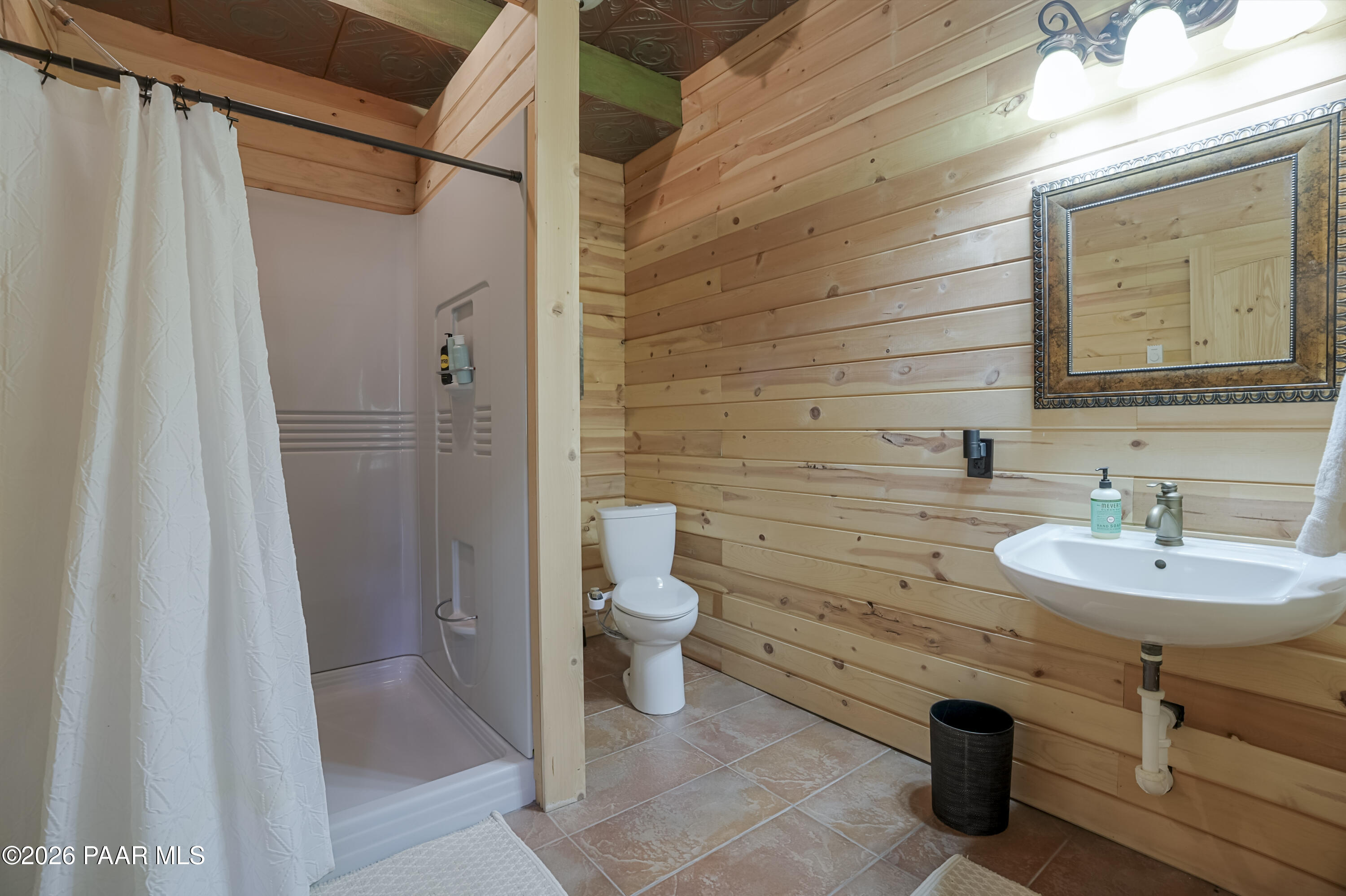 8105 South Comstock Mine Road Prescott, AZ 86303 - Photo 32 of 61 a bathroom with a toilet sink and shower