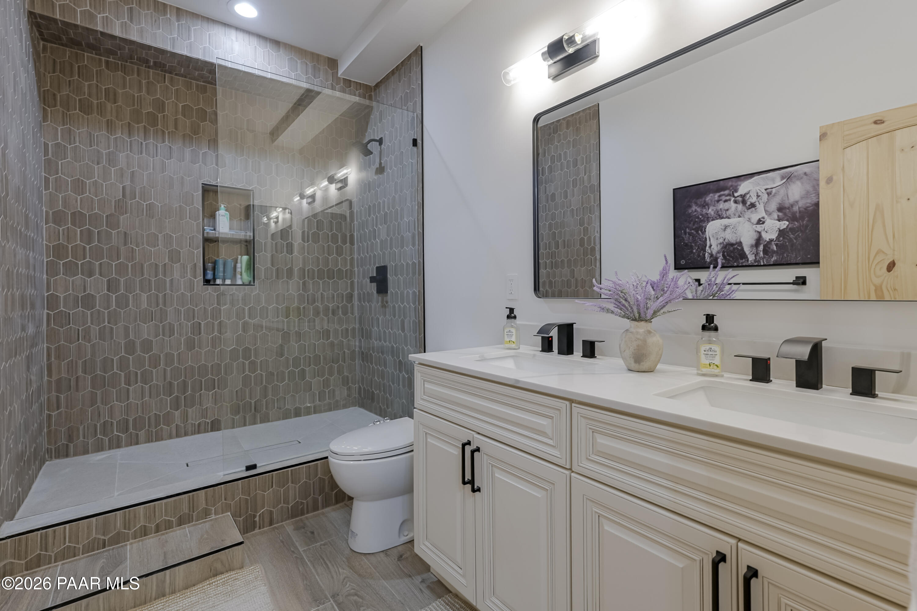 8105 South Comstock Mine Road Prescott, AZ 86303 - Photo 33 of 61 a bathroom with a double vanity sink toilet and shower