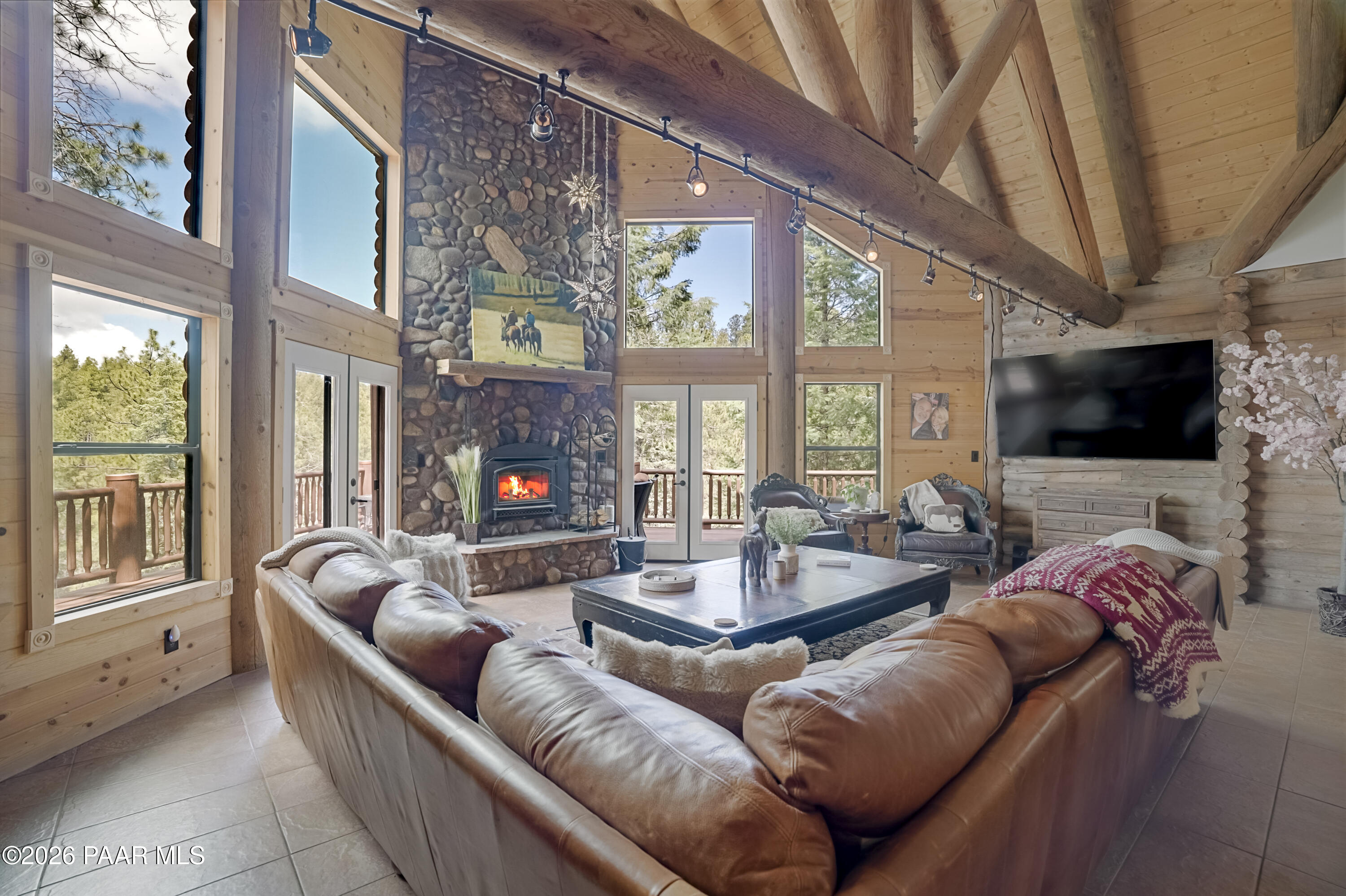 8105 South Comstock Mine Road Prescott, AZ 86303 - Photo 6 of 61 a living room with furniture a flat screen tv and a large window