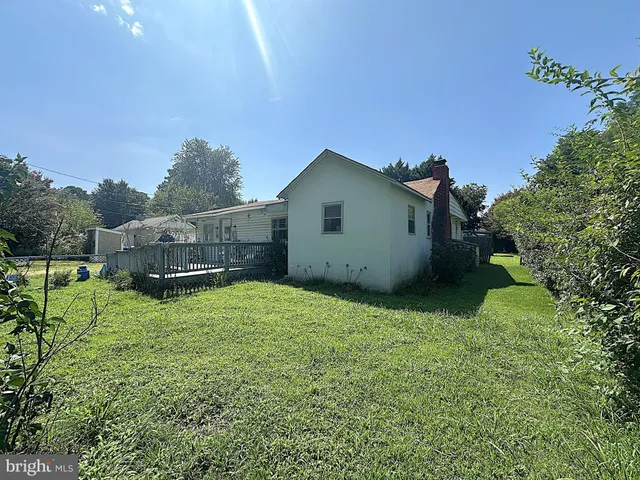 a backyard of a house with plants and outdoor seating
