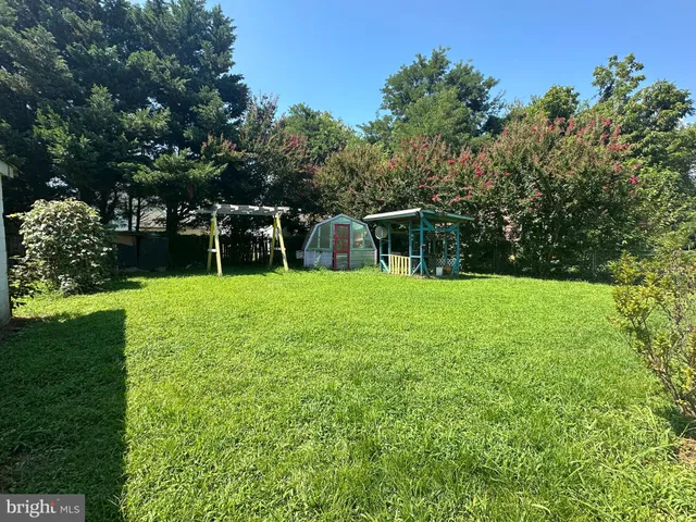 a view of a garden with a house