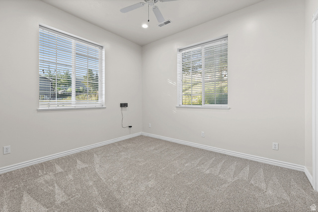 4117 North Wolf Ridge Circle Eden, UT 84310 - Photo 35 of 63 Room featuring neutral wall tones, two windows with blinds, a ceiling fan with integrated lighting, and light-toned carpeting