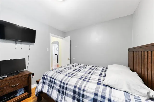 a bedroom with a bed and a flat screen tv