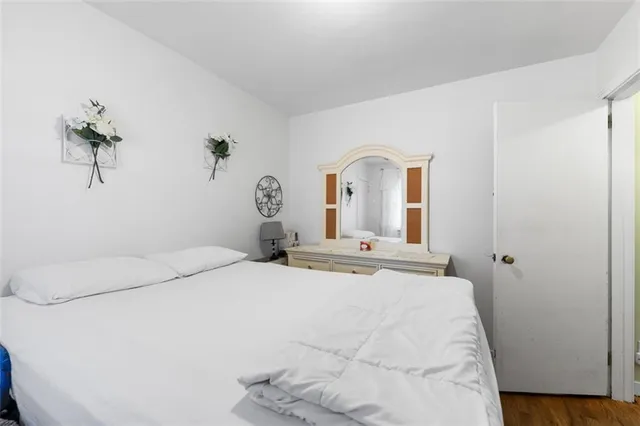 a bedroom with a bed and a potted plant