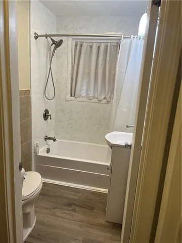 a bathroom with a shower a toilet and a shower