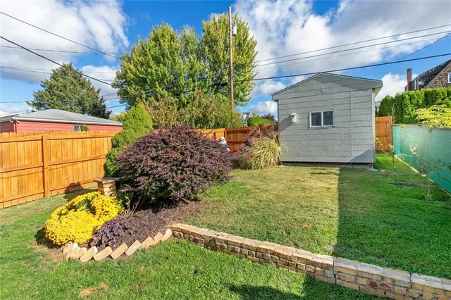 a view of a backyard with table and chairs and potted plants