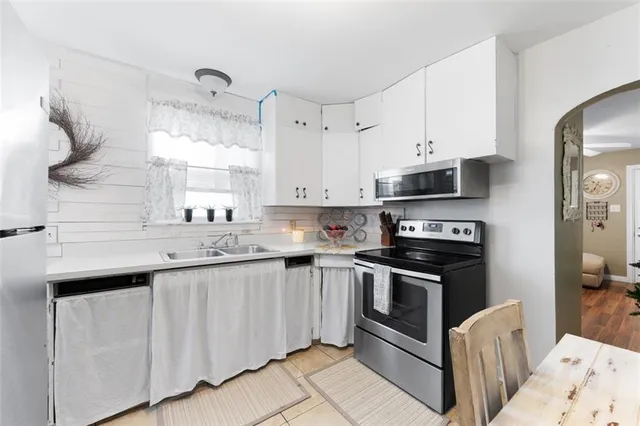 a kitchen with stainless steel appliances granite countertop a sink and a stove