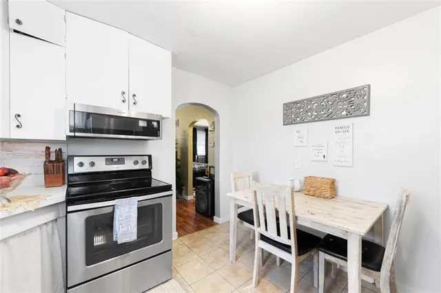 a kitchen with stainless steel appliances a stove microwave and cabinets