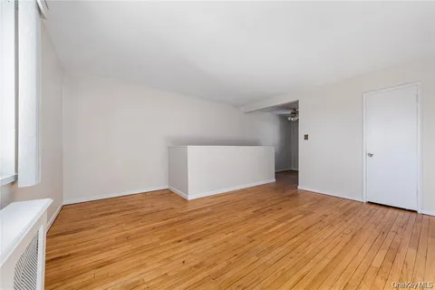 a view of an empty room and wooden floor
