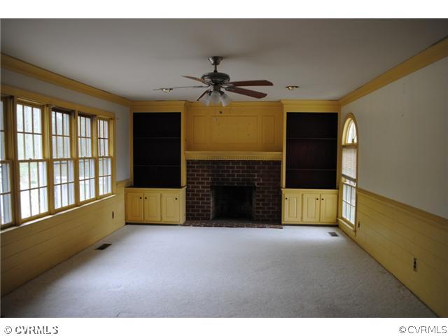 13620 Spring Run Road Midlothian, VA 23112 - Photo 2 of 15 a view of an empty room with a fireplace and a window