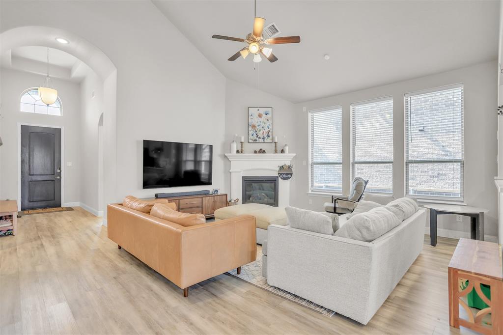 3522 Ridgecross Drive Rockwall, TX 75087 - Photo 6 of 34 Natural light flowing into the living room with fireplace.