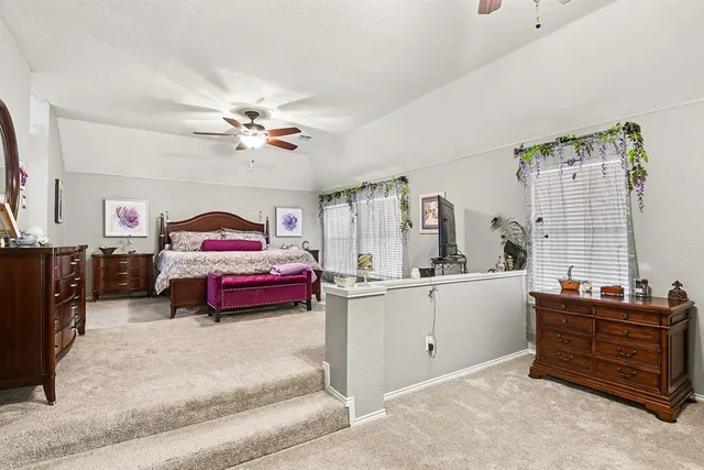a living room with furniture and kitchen space
