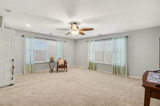 a view of a livingroom with furniture and a ceiling fan