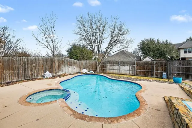 a swimming pool with wooden fence
