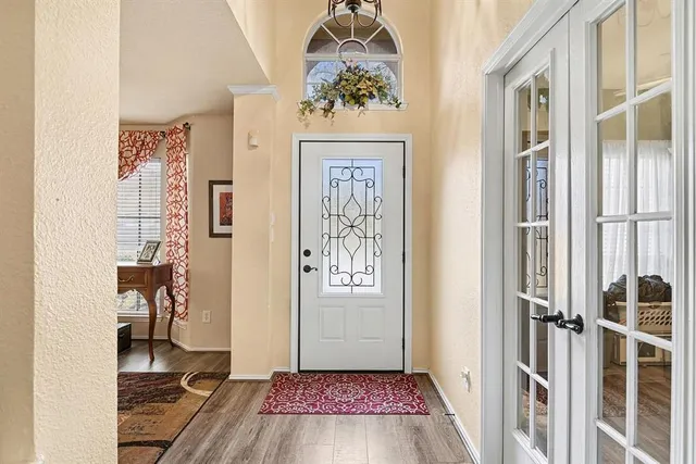 a view of an entryway with wooden floor