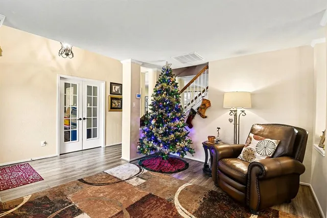 a living room with furniture and a potted plant