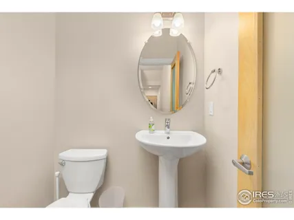 a bathroom with a granite countertop sink a toilet and a mirror