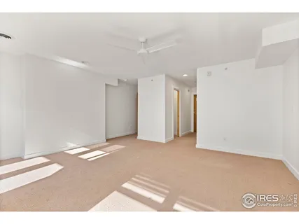 a living room with furniture and a book shelf