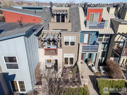 a view of a livingroom with furniture a flat screen tv and kitchen view