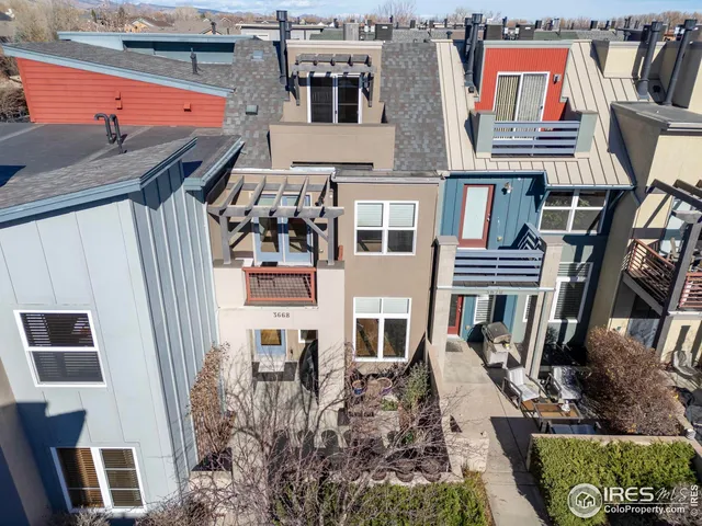 a view of a livingroom with furniture a flat screen tv and kitchen view
