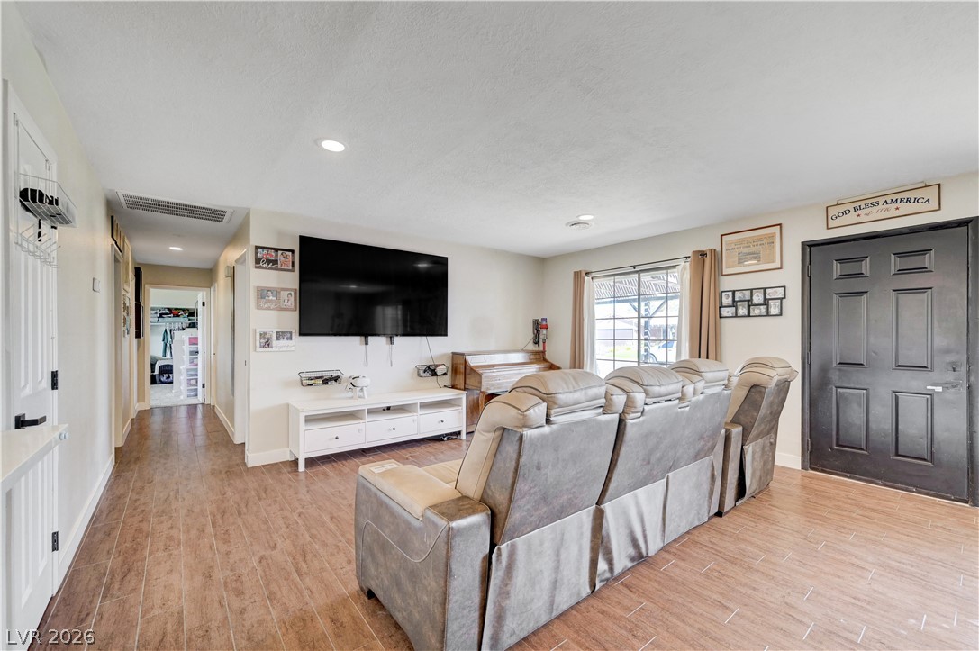 1331 Pinto Road Boulder City, NV 89005 - Photo 11 of 46 Recessed lighting illuminates wood-look flooring, creating a comfortable living area perfect for everyday enjoyment.