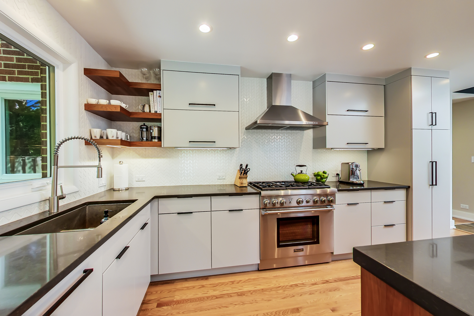 416 Maple Street Winnetka, IL 60093 - Photo 3 of 34 a kitchen with stainless steel appliances granite countertop a sink stove and cabinets