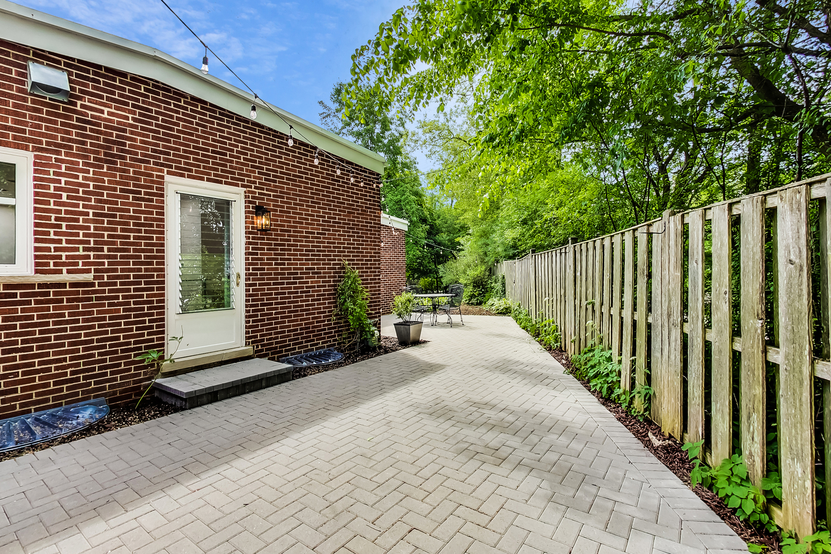 416 Maple Street Winnetka, IL 60093 - Photo 27 of 34 a view of a house with a small yard and wooden fence