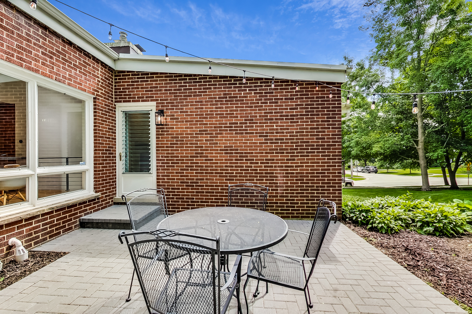 416 Maple Street Winnetka, IL 60093 - Photo 28 of 34 a view of a patio with a table and chairs and potted plants