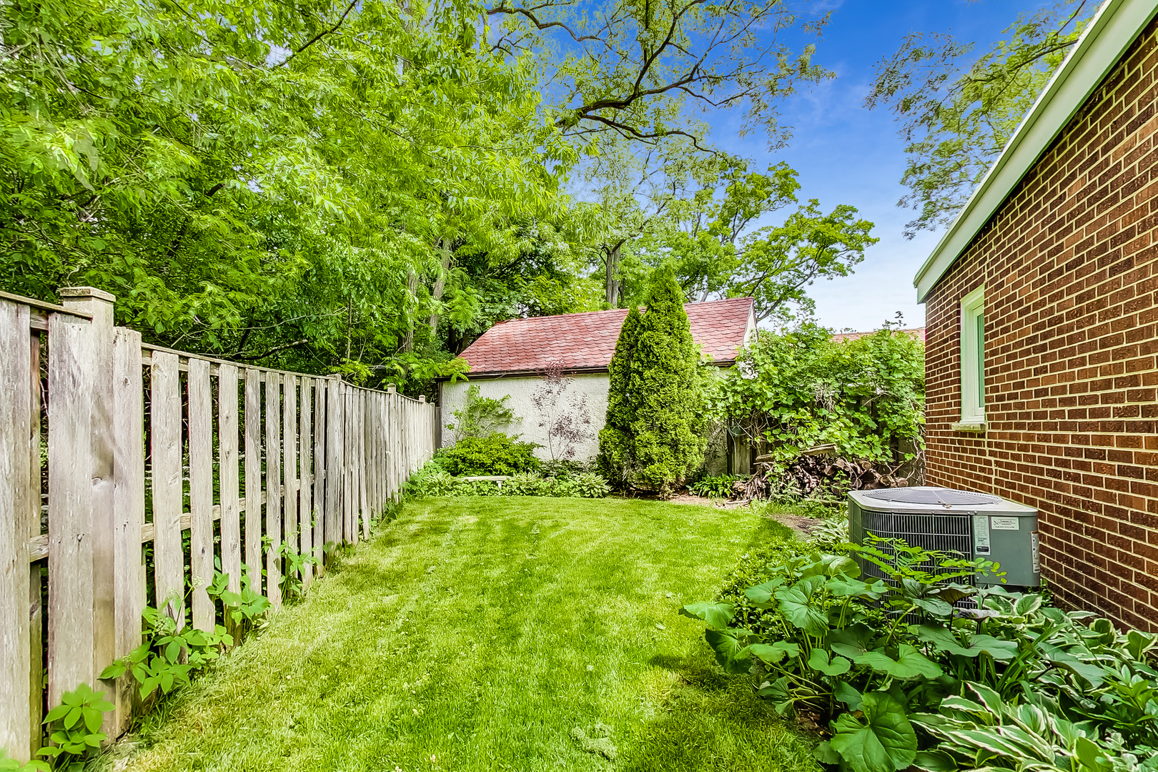 416 Maple Street Winnetka, IL 60093 - Photo 30 of 34 a view of a backyard with wooden fence