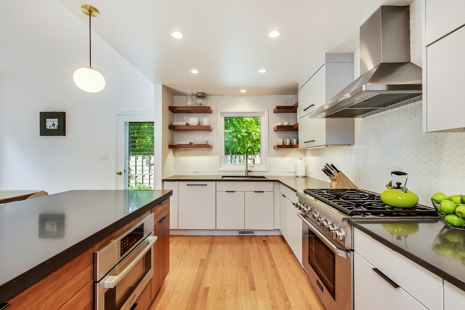 416 Maple Street Winnetka, IL 60093 - Photo 4 of 34 a kitchen with stainless steel appliances granite countertop a sink a stove and a wooden floors