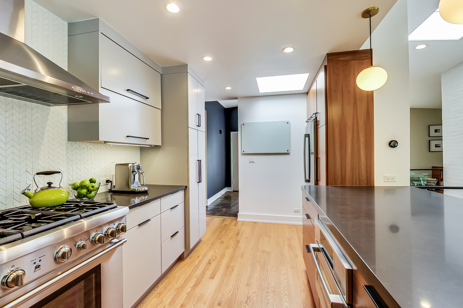 416 Maple Street Winnetka, IL 60093 - Photo 5 of 34 a kitchen with stainless steel appliances a sink stove and refrigerator